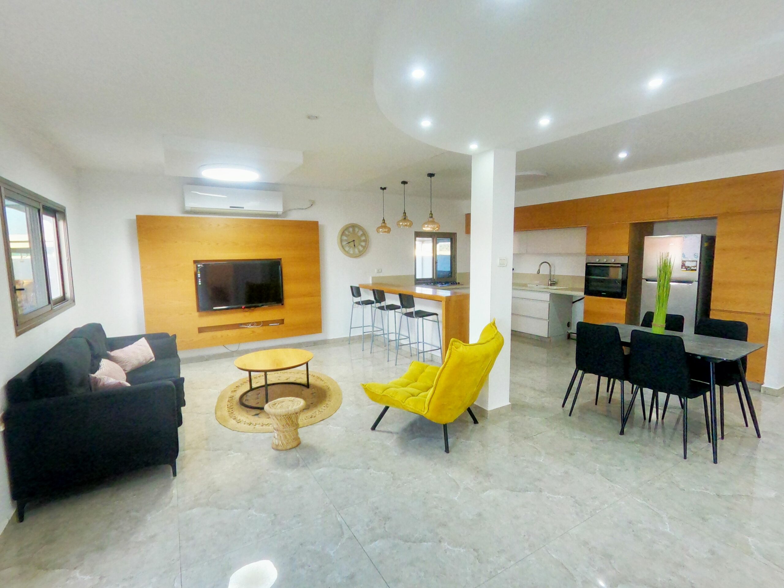 Spacious open-concept living and dining room featuring contemporary design and bright lighting.